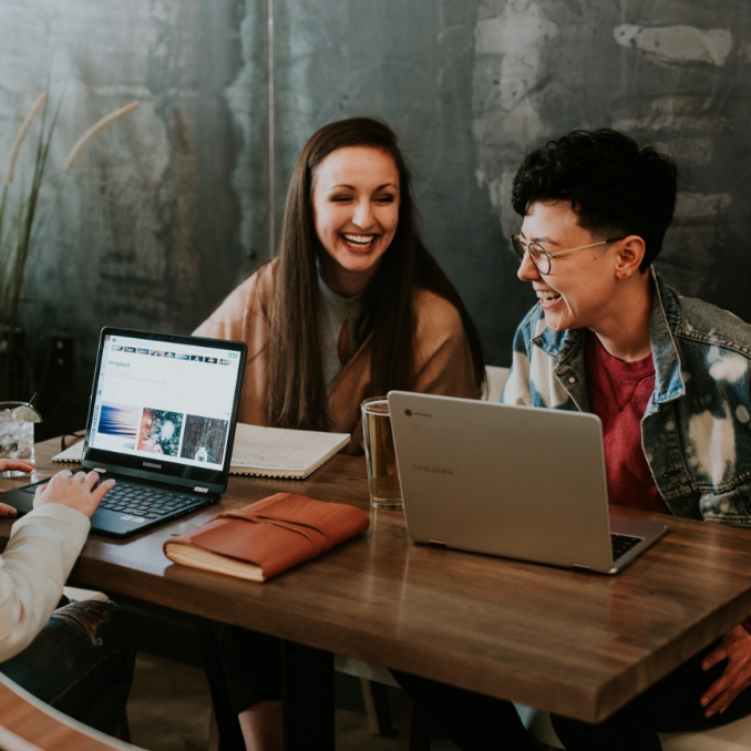 Two women having fun while working